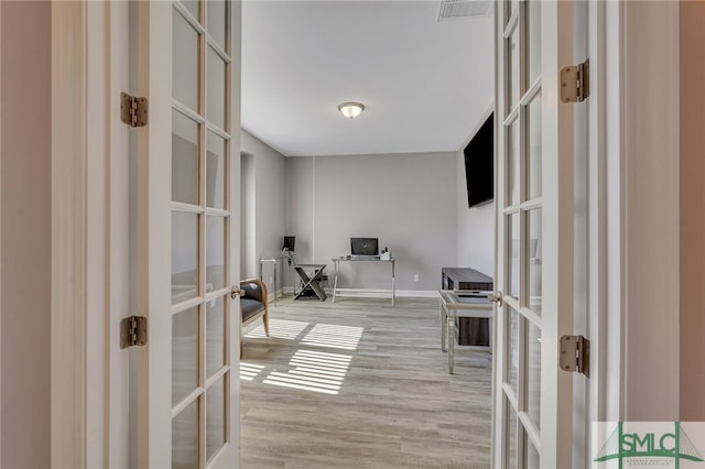 office area with french doors and light hardwood / wood-style flooring