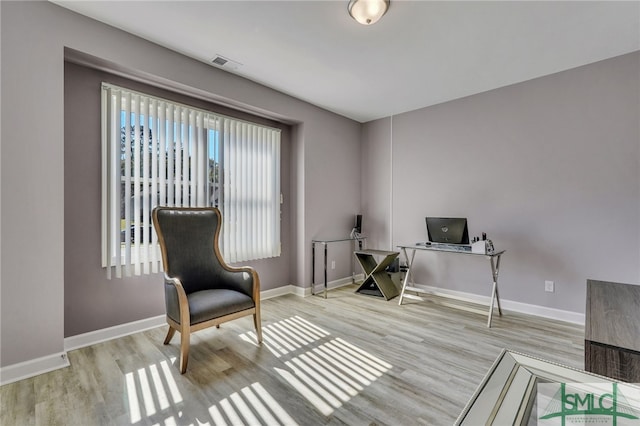 sitting room with light hardwood / wood-style flooring