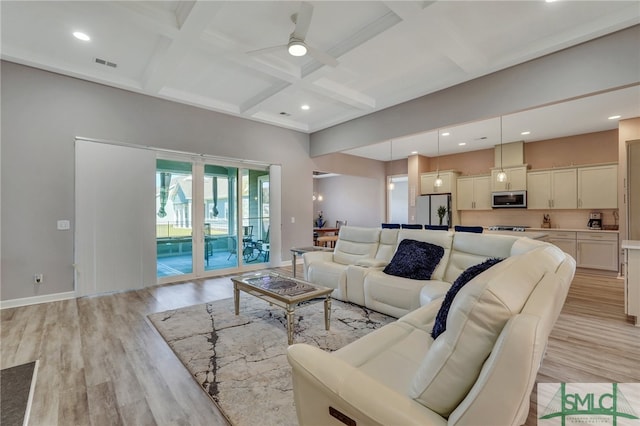 living room with ceiling fan, light hardwood / wood-style floors, beamed ceiling, and coffered ceiling