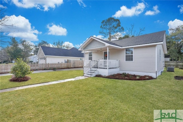 view of front of home featuring a porch, a front yard, and cooling unit