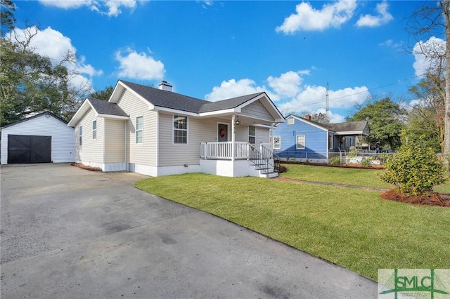 bungalow featuring a porch, a garage, an outdoor structure, and a front lawn