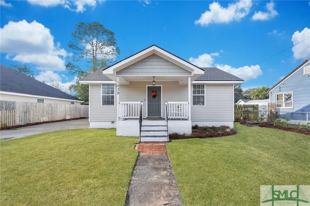 bungalow featuring a porch and a front lawn