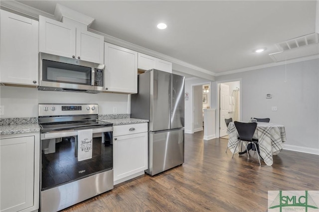 kitchen with white cabinets, appliances with stainless steel finishes, light stone counters, and crown molding