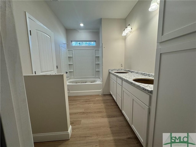 bathroom with vanity, wood-type flooring, and shower / washtub combination