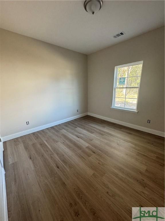 unfurnished room with light wood-type flooring