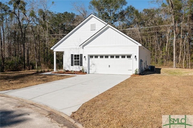 view of front of home with a garage, central air condition unit, concrete driveway, and a front yard