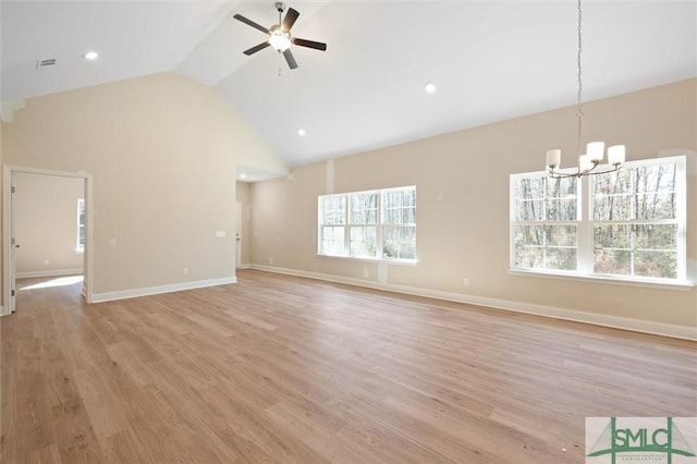 unfurnished living room featuring baseboards, visible vents, light wood finished floors, and ceiling fan with notable chandelier