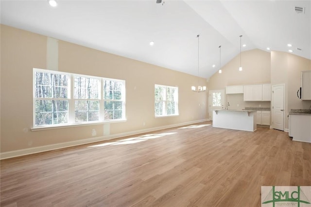 unfurnished living room with high vaulted ceiling, recessed lighting, visible vents, baseboards, and light wood finished floors