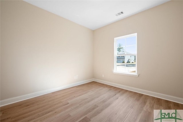 unfurnished room with light wood-style floors, baseboards, and visible vents