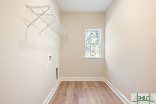 washroom with washer hookup, hookup for an electric dryer, light wood-type flooring, laundry area, and baseboards