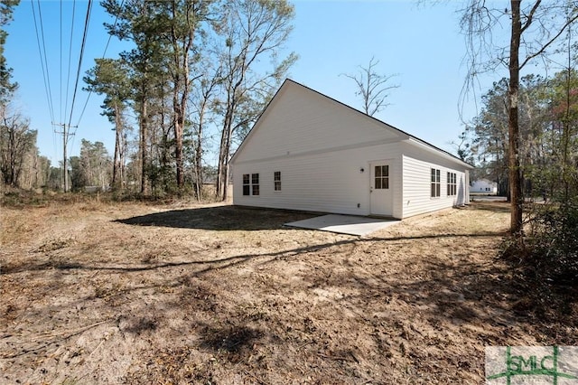 view of side of home with a patio