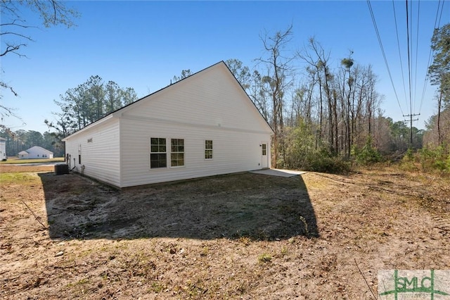 view of side of home with central AC