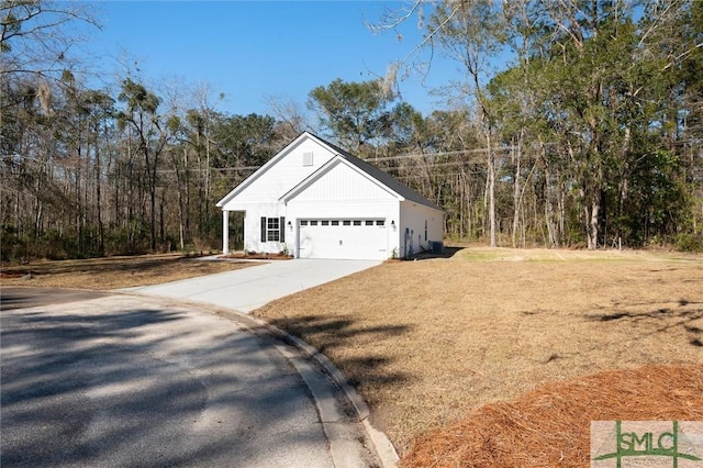 view of home's exterior featuring a garage, concrete driveway, and a yard