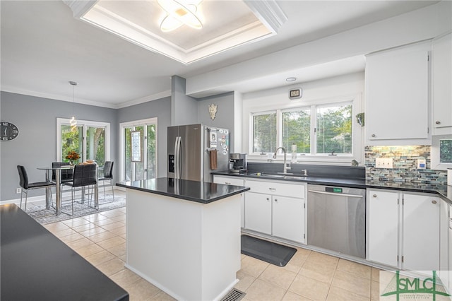 kitchen featuring white cabinets, a wealth of natural light, sink, and appliances with stainless steel finishes