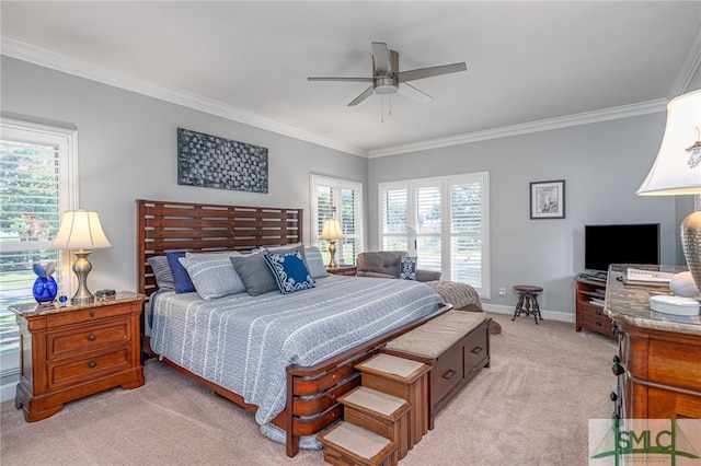 carpeted bedroom with ceiling fan and ornamental molding