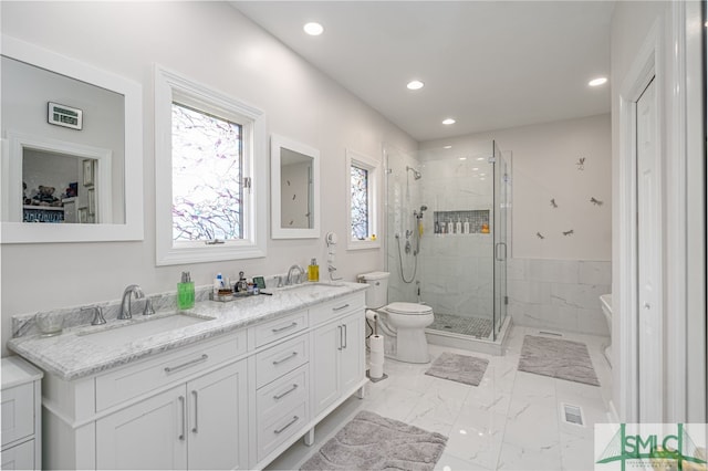 bathroom with walk in shower, vanity, and toilet