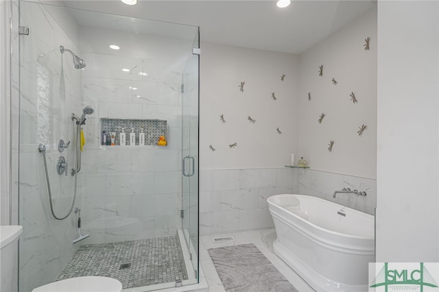 bathroom featuring shower with separate bathtub