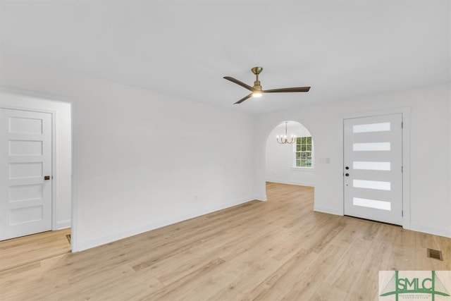 entrance foyer featuring ceiling fan with notable chandelier and light hardwood / wood-style flooring