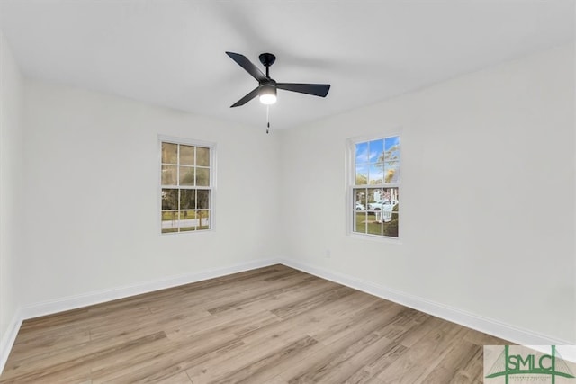 spare room with ceiling fan, light hardwood / wood-style floors, and a healthy amount of sunlight