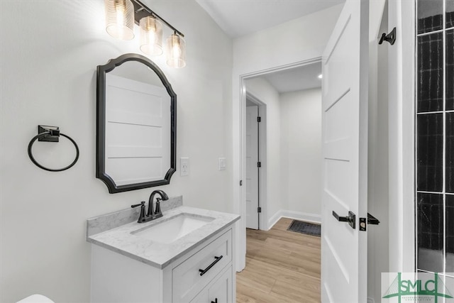 bathroom with hardwood / wood-style floors and vanity