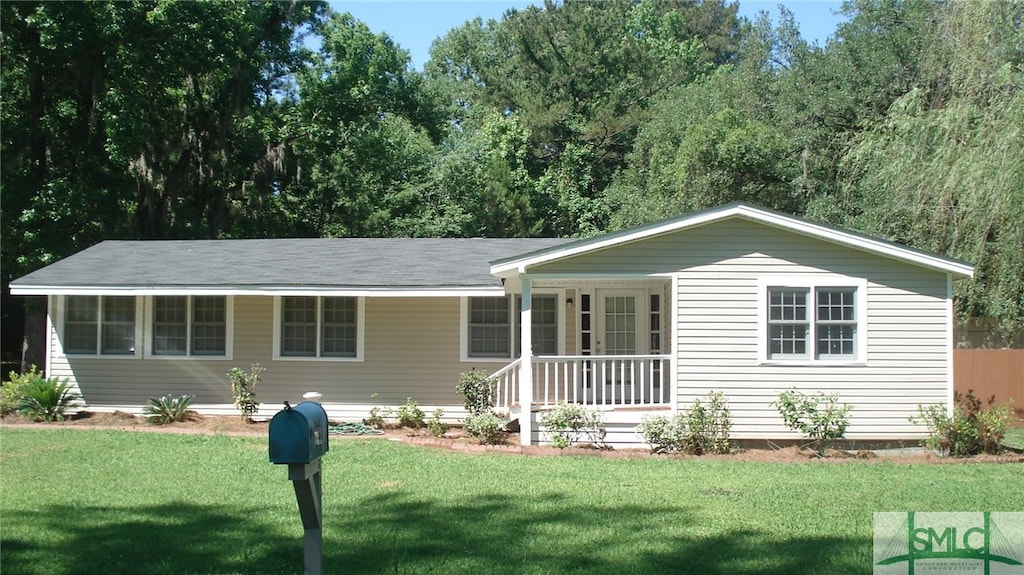 ranch-style home with a porch and a front lawn