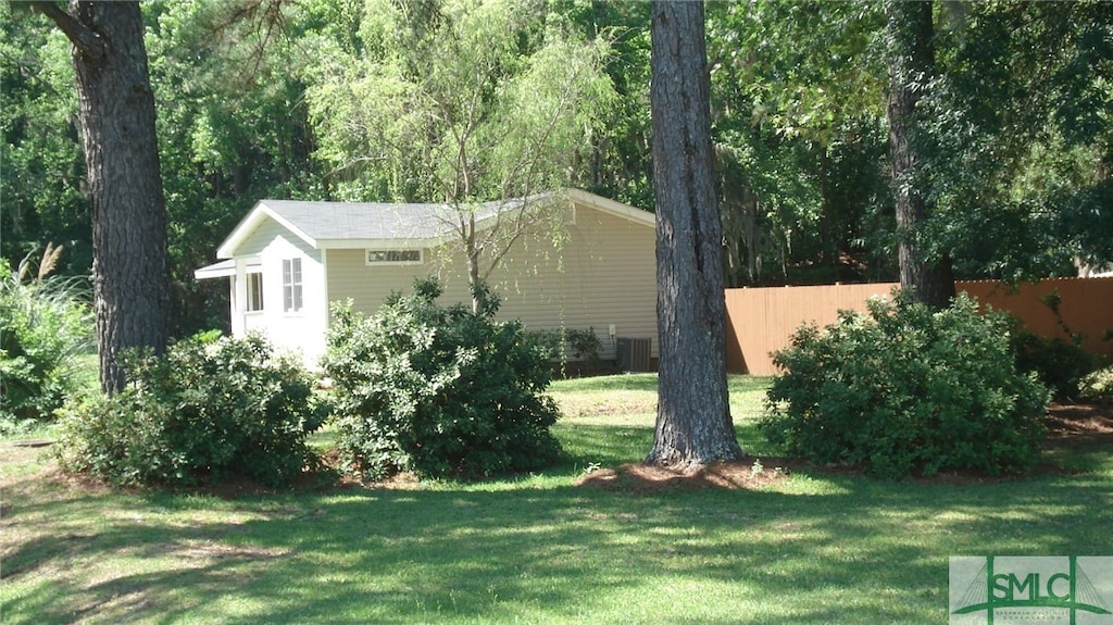 view of home's exterior featuring central AC and a yard