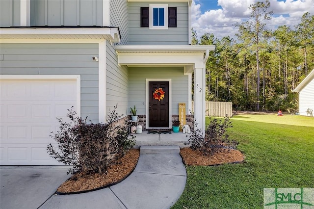 property entrance with a yard and a garage