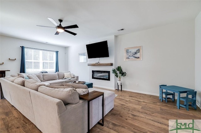 living room featuring ceiling fan and wood-type flooring