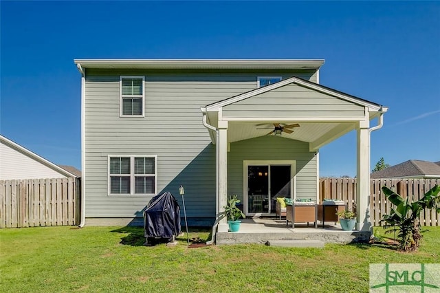 back of house featuring a yard, ceiling fan, and a patio area