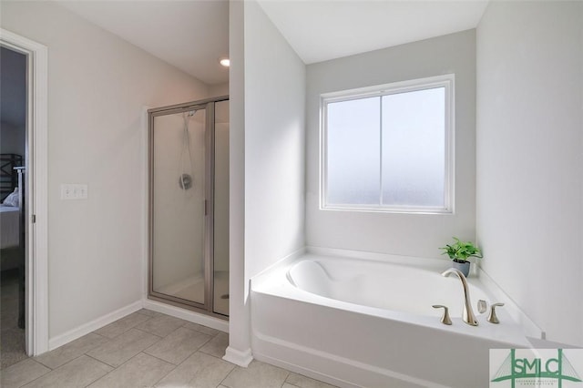 bathroom with tile patterned floors and independent shower and bath