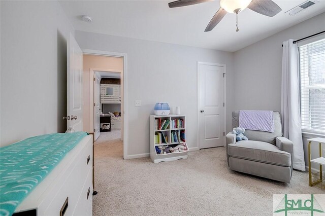 bedroom featuring light colored carpet and ceiling fan