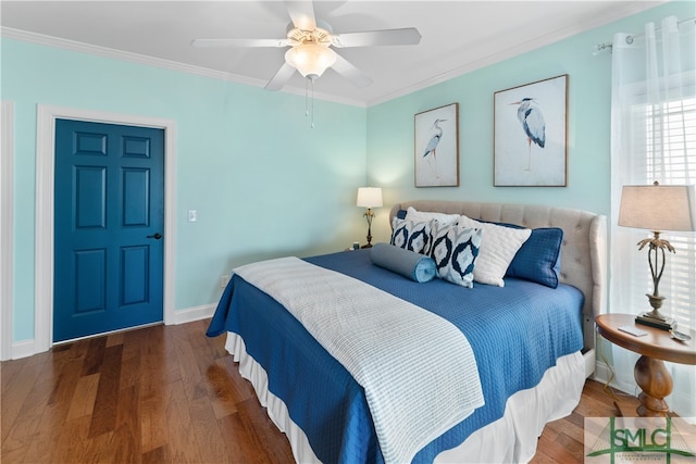 bedroom with ceiling fan, dark hardwood / wood-style flooring, and ornamental molding