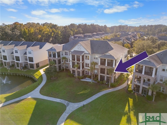 birds eye view of property with a water view