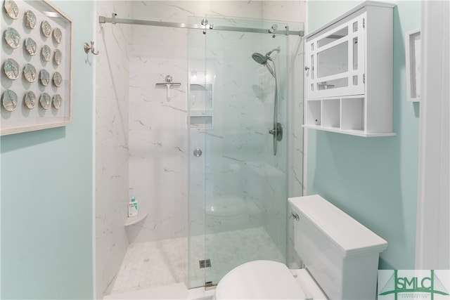 bathroom with toilet and a shower with shower door