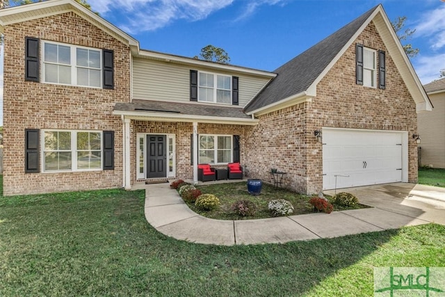 view of property featuring a garage and a front lawn