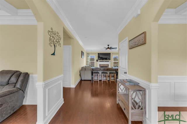 hallway featuring dark wood-type flooring and ornamental molding