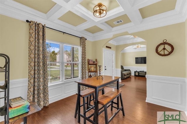 dining space featuring beam ceiling, an inviting chandelier, crown molding, coffered ceiling, and dark hardwood / wood-style flooring