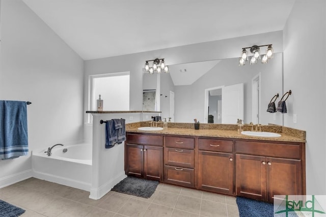 bathroom featuring tile patterned flooring, a washtub, lofted ceiling, and vanity