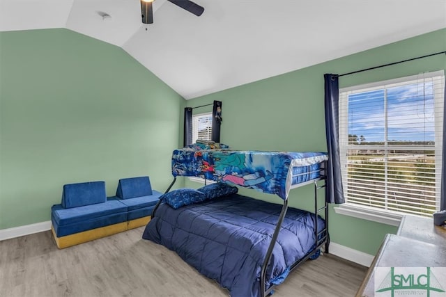 bedroom with light wood-type flooring, lofted ceiling, and ceiling fan