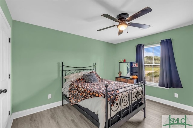 bedroom with hardwood / wood-style flooring and ceiling fan