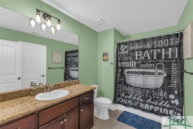 bathroom with tile patterned flooring, curtained shower, vanity, and toilet