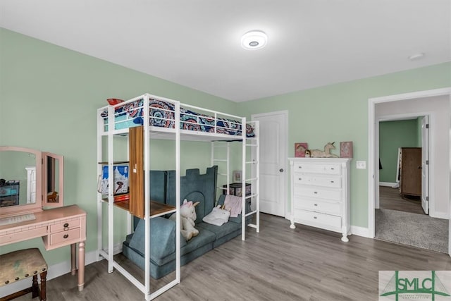 bedroom with hardwood / wood-style flooring