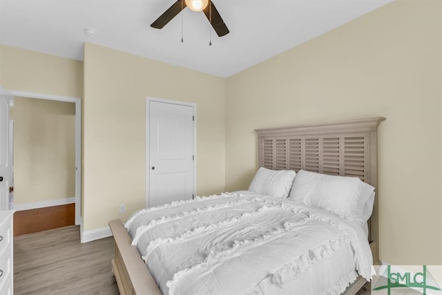 bedroom with light hardwood / wood-style flooring and ceiling fan