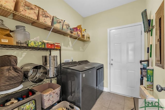 washroom with light tile patterned floors and washer and clothes dryer