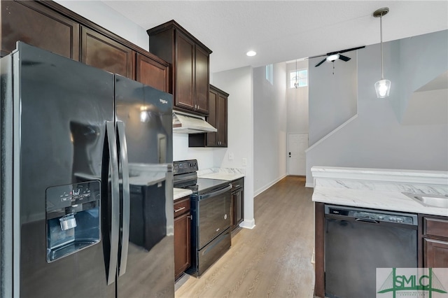 kitchen featuring black appliances, ceiling fan, dark brown cabinets, light hardwood / wood-style flooring, and decorative light fixtures