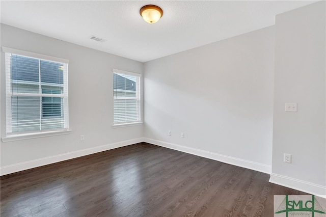 unfurnished room with dark hardwood / wood-style floors