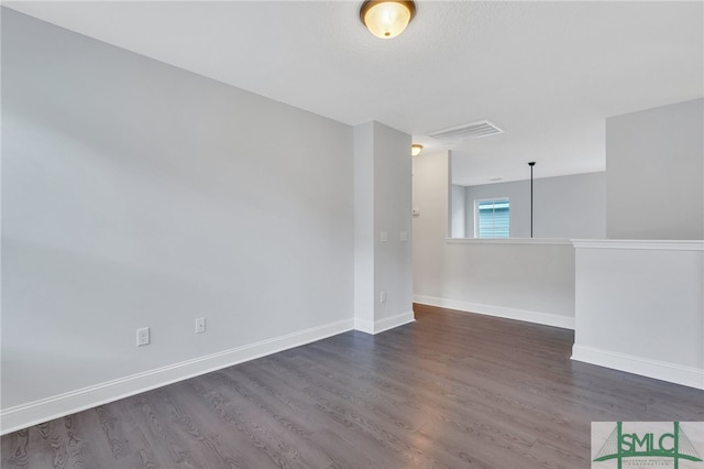 spare room with dark wood-type flooring