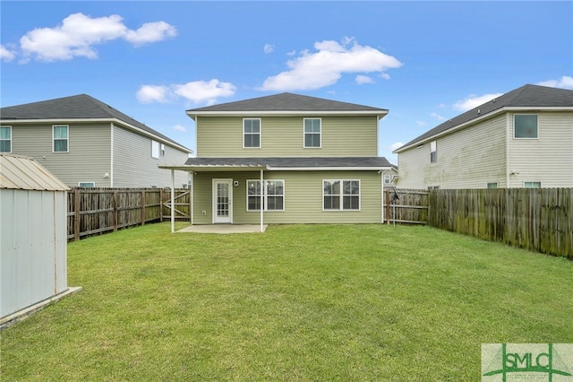 rear view of house featuring a patio area, a lawn, and a storage unit