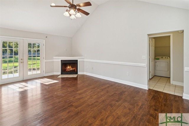 unfurnished living room featuring french doors, ceiling fan, high vaulted ceiling, light hardwood / wood-style flooring, and washer / dryer