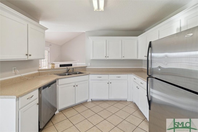 kitchen with white cabinets, stainless steel appliances, light tile patterned flooring, and sink